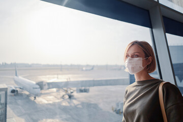 New normal and social distance concept. Young woman tourist wearing face mask during corona virus...