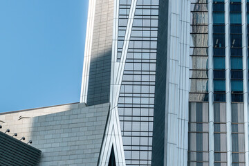 Fototapeta na wymiar Low angle shot of exterior glass of urban office building