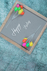 Happy friday embedded on grey background with toy balloons