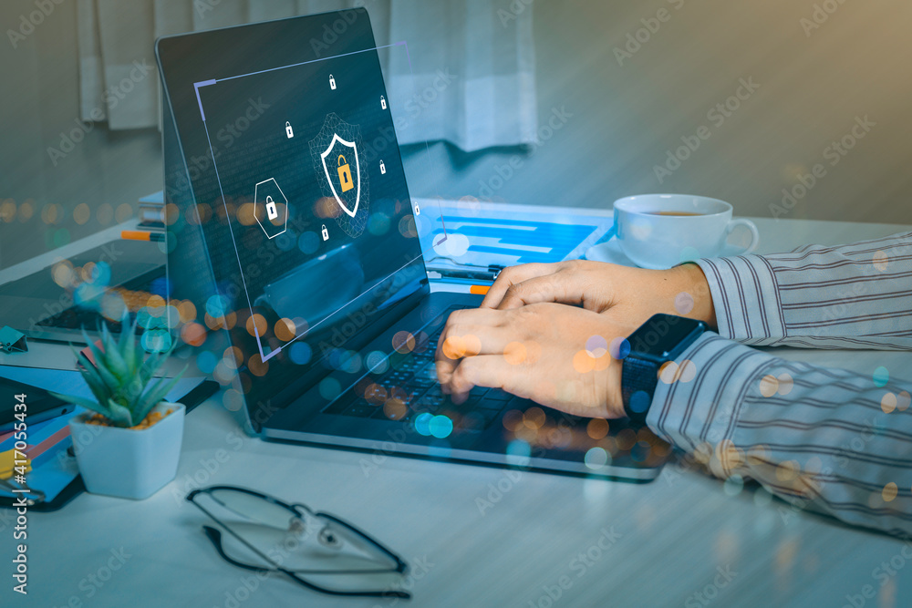 Poster person using a laptop computer with data protection, cyber security, information safety and encrypti
