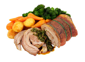 Roasted rolled lamb breast meat partly sliced with mixed vegetables isolated on a white background