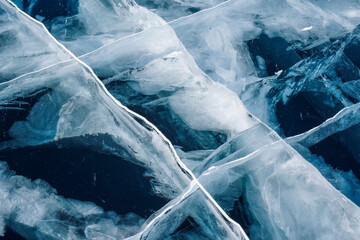 Perfect desktop wallpaper. Numerous streaks of cracks in the transparent blue clear ice. Amazing patterns. Horizontally. Baikal Lake, Russia