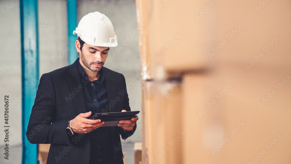 Poster factory manager using tablet computer in warehouse or factory . industry and supply chain management