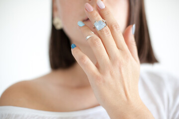 Cropped photo of a woman with short dark hair in white clothes on white background. Portrait of a...