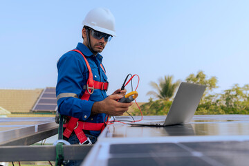 An Engineer use a laptop computer to inspection the solar panels at roof top