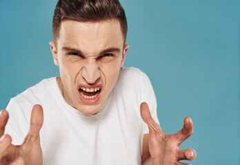 Angry man white t-shirt emotions cropped view blue background