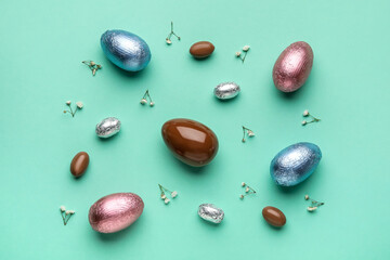 Composition with chocolate Easter eggs on color background