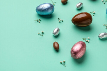 Composition with chocolate Easter eggs on color background