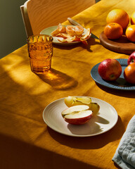 Food, breakfast with fruit. Summer or spring sunny day or evening on terrace, table covering bright...