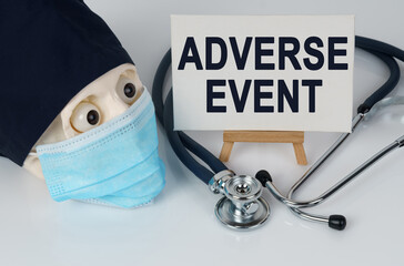 Skull in mask and cap, stethoscope and easel with canvas on which it is written - ADVERSE EVENT