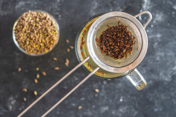 Hot healthy tea with fresh birch buds in spring, close up, top view