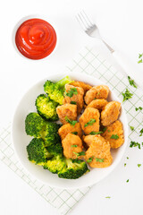 Chicken nuggets with vegetables, broccoli and ketchup on a white background