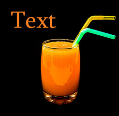 Glass cup with freshly squeezed orange juice on a black background. Free space for your text.