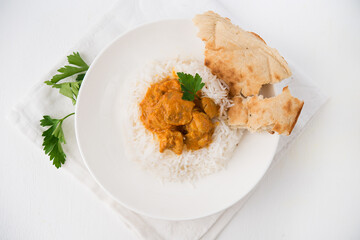 Chicken with rice in curry sauce-a traditional Indian dish on a white background