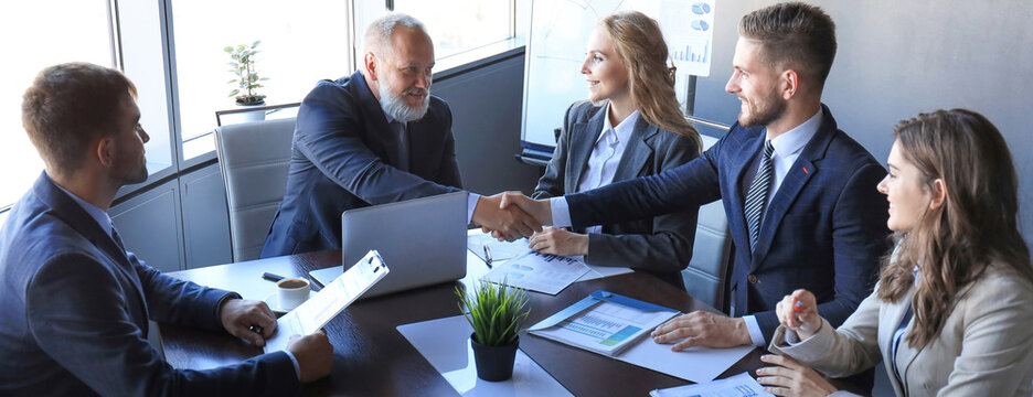 Business people shaking hands, finishing up a meeting.