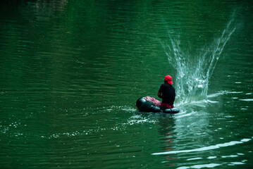 Fisher waist deep in a river fishing