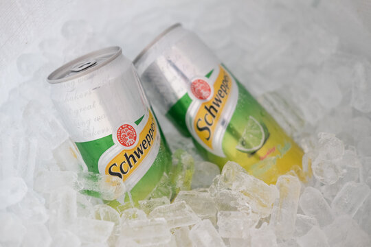 Bangkok, Thailand - February 28, 2021 : Two can aluminium Schweppes manao soda on ice basket.