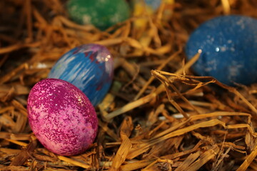 beautiful colorful Easter eggs lie on the straw