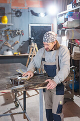 Male carpenter working on old wood in a retro vintage workshop.