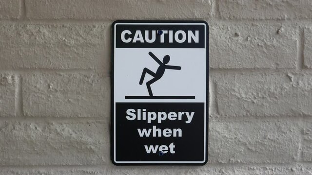 Caution slippery when a wet sign on the wall with 4k resolution