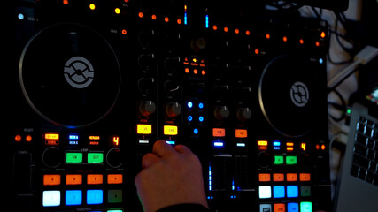 DJ at work in a nightclub. dj console