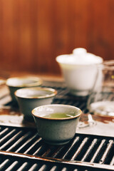 Chinese tea ceremony.Ceramic tea bowl, porcelain gaiwan on a wooden chaban.