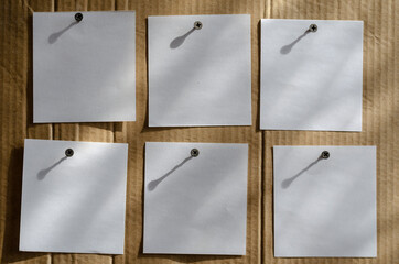 Six Note Paper Stickers are screwed to the brown cardboard with metal screws.