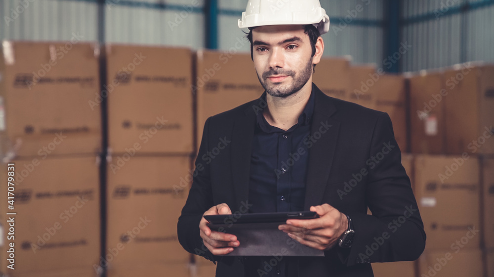 Poster factory manager using tablet computer in warehouse or factory . industry and supply chain management