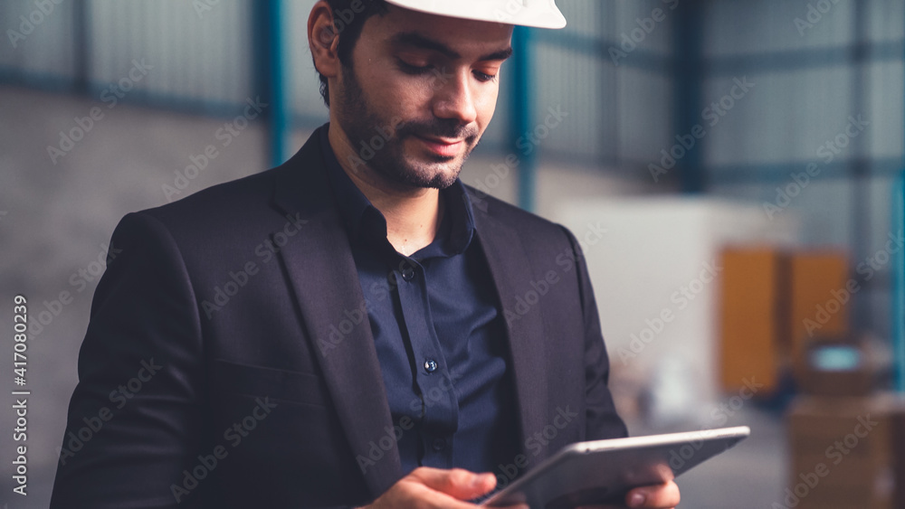 Poster factory manager using tablet computer in warehouse or factory . industry and supply chain management