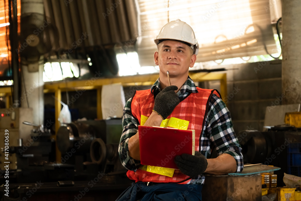 Poster manufacturing worker working with clipboard to do job procedure checklist . factory production line 