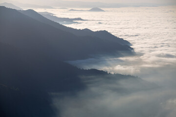Fototapeta na wymiar mountains high in the sun beam and a sea of clouds beneath