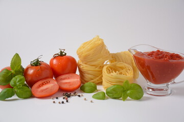 Food ingredients for Italian pasta, tomatoes basil garlic olive oil and parmesan cheese