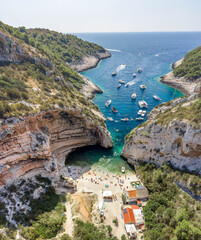 Aerial drone shot of tourists swim sunbath at Stiniva cove beach of Adriatic sea on Vis Island in...