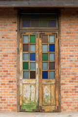 An old wooden door in a brick wall.