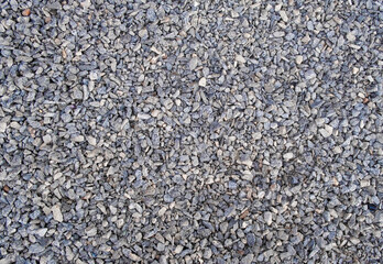 lie gray stones or gravel by a large fawn