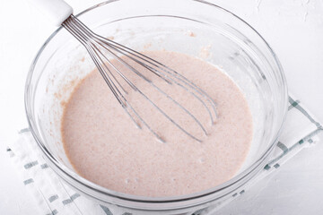 Yeast blini dough in the glass bowl before fermentation. Step by step recipe of crepes with rye flour. Step 5