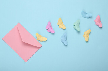 Envelope and origami butterflies on a blue background