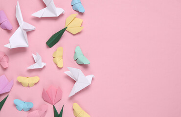 Spring composition of origami doves, butterflies, tulips on a pink background. Copy space