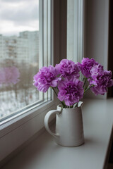 bouquet of flowers on a white windowsill