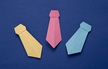 Paper origami bow ties on blue background