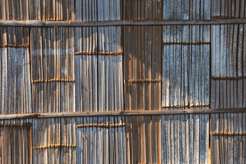 Beautiful patterned bamboo wall, hill tribe house, sunlight