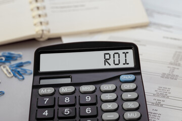 Calculator with the text ROI - Return on Investment on display