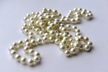White pearl necklace beads on white background