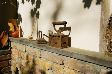 vintage iron. retro coal heated iron on a stone shelf