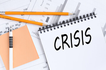 Crisis . text on white notepad paper on white background.