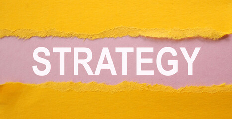 STRATEGY. text on white paper over torn paper background.