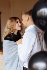 Fototapeta premium A young man and a woman embrace in a loft-style interior