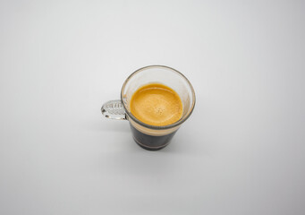 Close up of a glass of espresso isolated on white