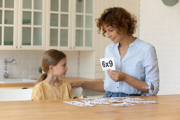 I like learning maths. Happy mother teach small child daughter mathematics using flash cards....