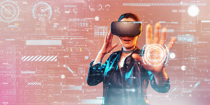 Young girl getting experience VR headset is using augmented reality eyeglasses being in virtual reality. Girl with hands up wearing virtual reality goggles. Woman touching air during VR experience